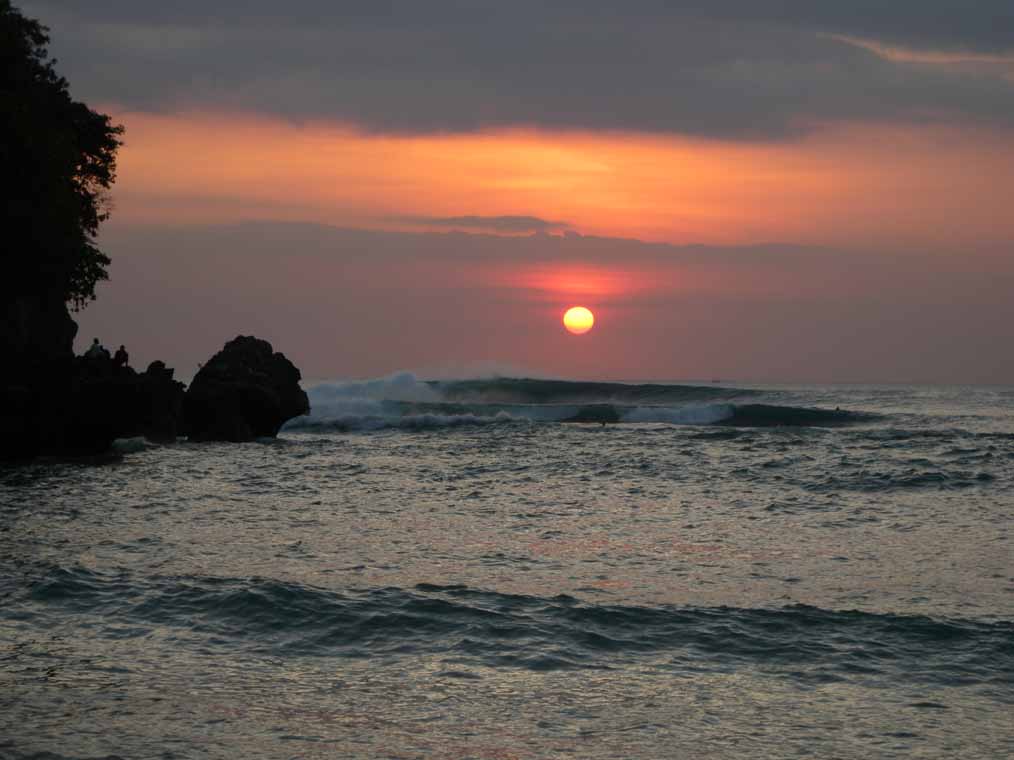 Surfing the big sets at sunset, Padang Padang
