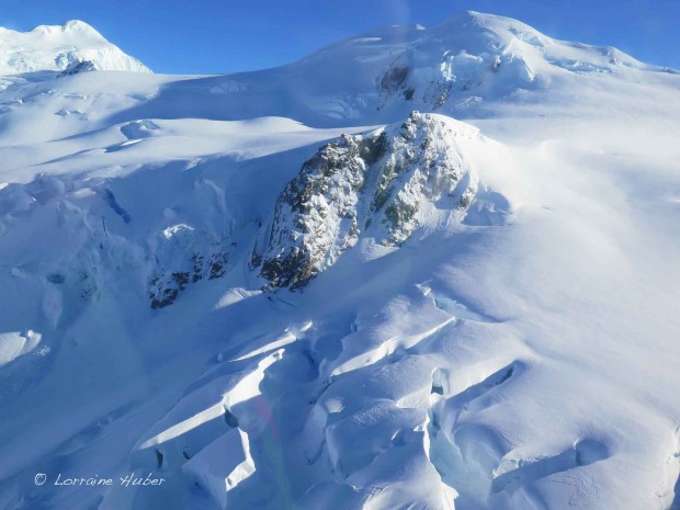 The Tasman Saddle Hut (2300m) is perched on a slippery ridge above big exposure